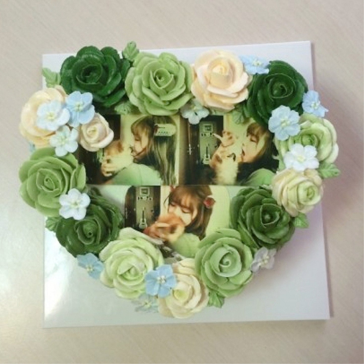 Heart photo cake with green and cream roses and blue flowers showing girl and dog printed photos Canon edible ink bundle