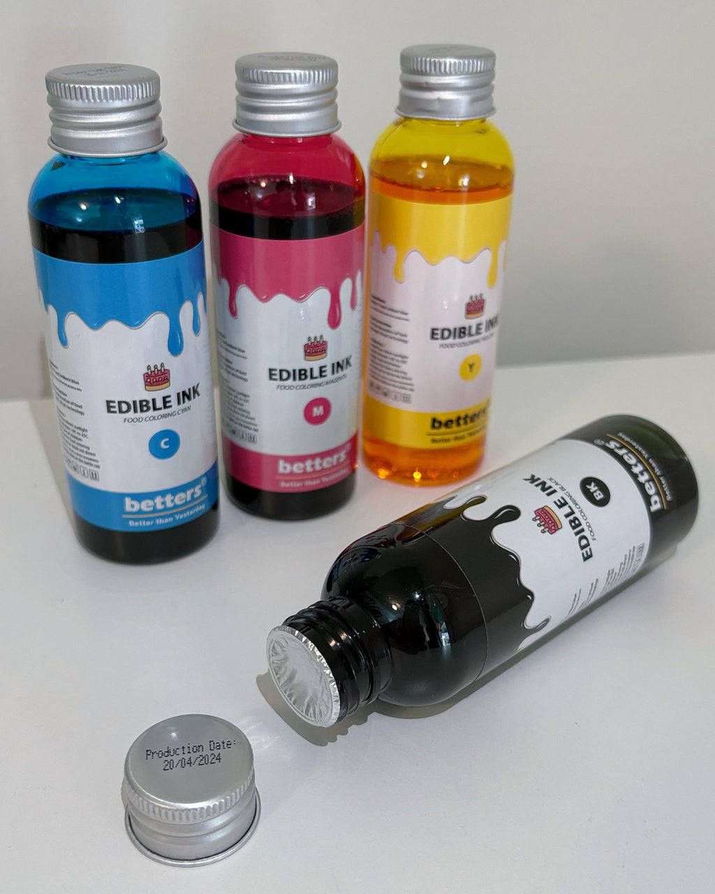 Betters shop edible ink refill set four bottles cyan magenta yellow black one bottle open with cap showing production date