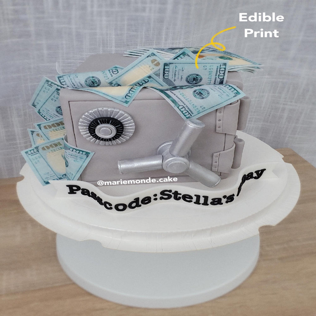 Silver vault cake with edible print dollar bills on top made using food-safe ink for cake decorating