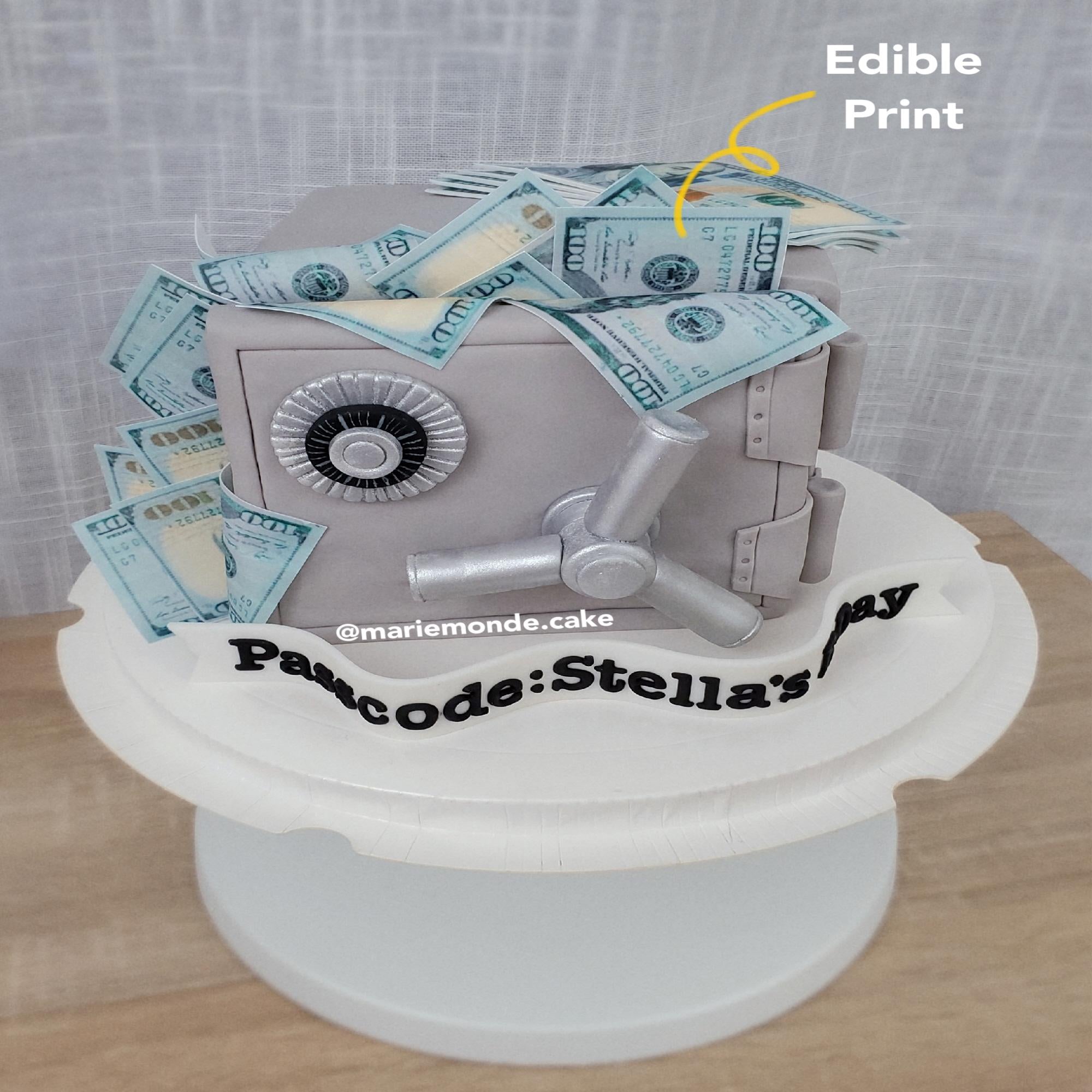 Silver vault cake with edible print dollar bills on top made using food-safe ink for cake decorating